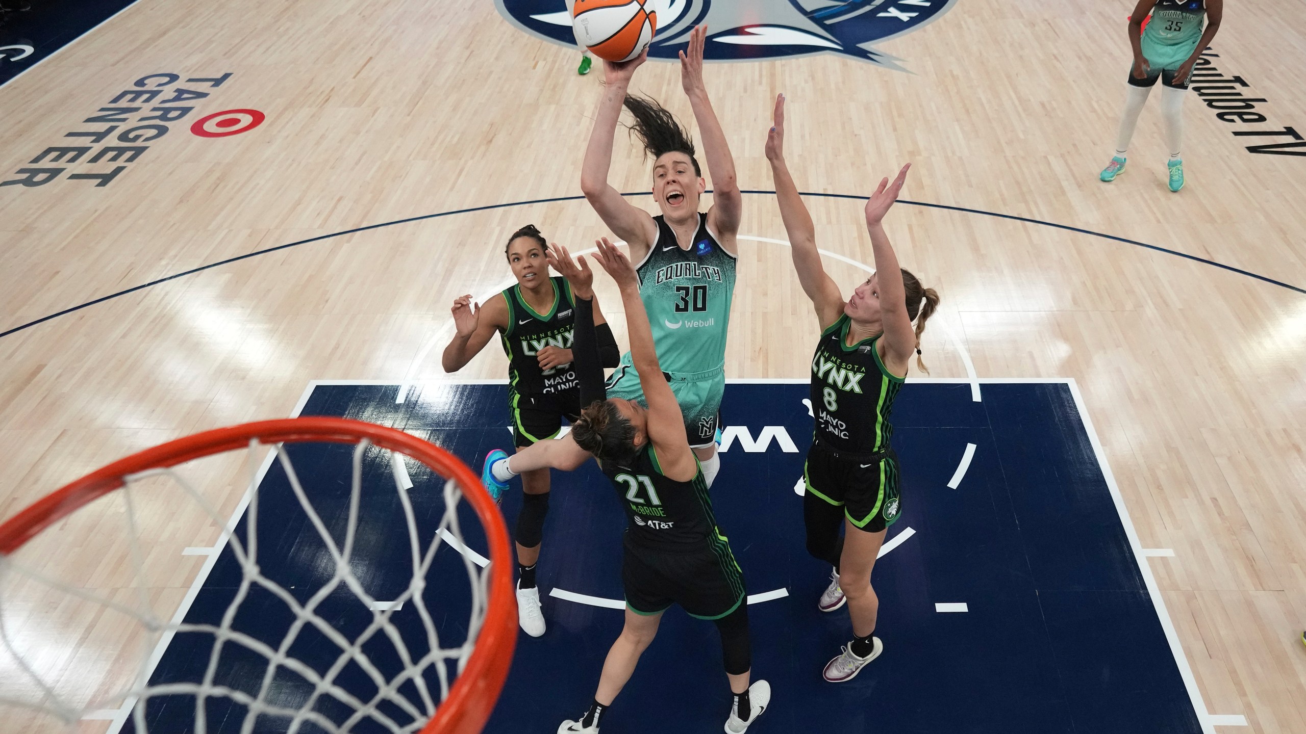 New York Liberty forward Breanna Stewart (30) shoots against Minnesota Lynx forward Napheesa Collier, left, guard Kayla McBride (21) and forward Alanna Smith (8) during the second half of Game 3 of a WNBA basketball final playoff series, Wednesday, Oct. 16, 2024, in Minneapolis. (AP Photo/Abbie Parr)