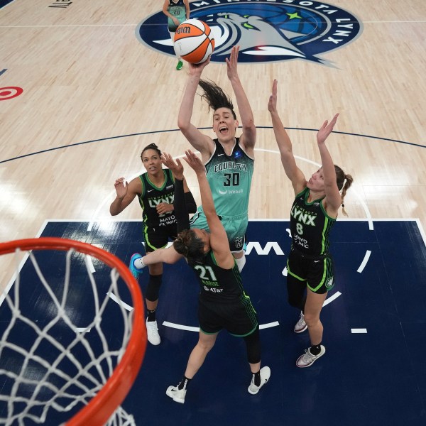 New York Liberty forward Breanna Stewart (30) shoots against Minnesota Lynx forward Napheesa Collier, left, guard Kayla McBride (21) and forward Alanna Smith (8) during the second half of Game 3 of a WNBA basketball final playoff series, Wednesday, Oct. 16, 2024, in Minneapolis. (AP Photo/Abbie Parr)