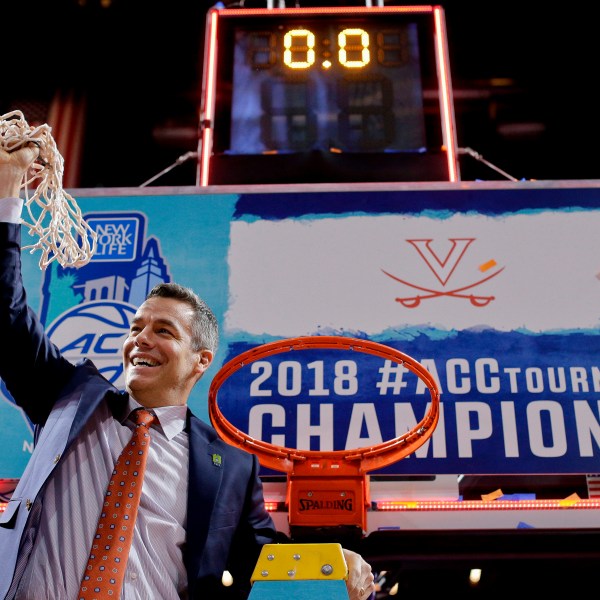 FILE - Virginia head coach Tony Bennett holds up the net after defeating North Carolina in the championship game of the NCAA Atlantic Coast Conference men's college basketball tournament in New York, March 10, 2018. (AP Photo/Julie Jacobson, File)