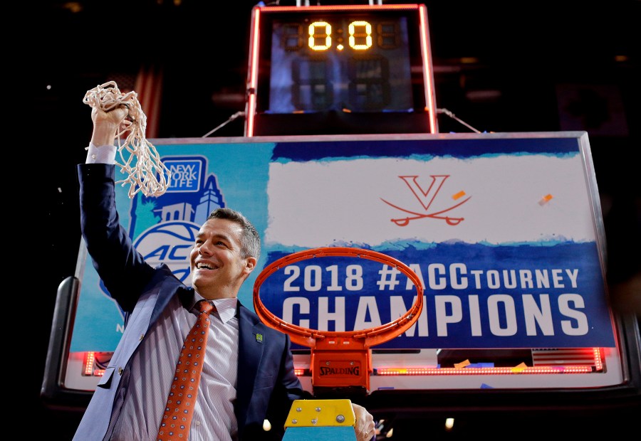 FILE - Virginia head coach Tony Bennett holds up the net after defeating North Carolina in the championship game of the NCAA Atlantic Coast Conference men's college basketball tournament in New York, March 10, 2018. (AP Photo/Julie Jacobson, File)