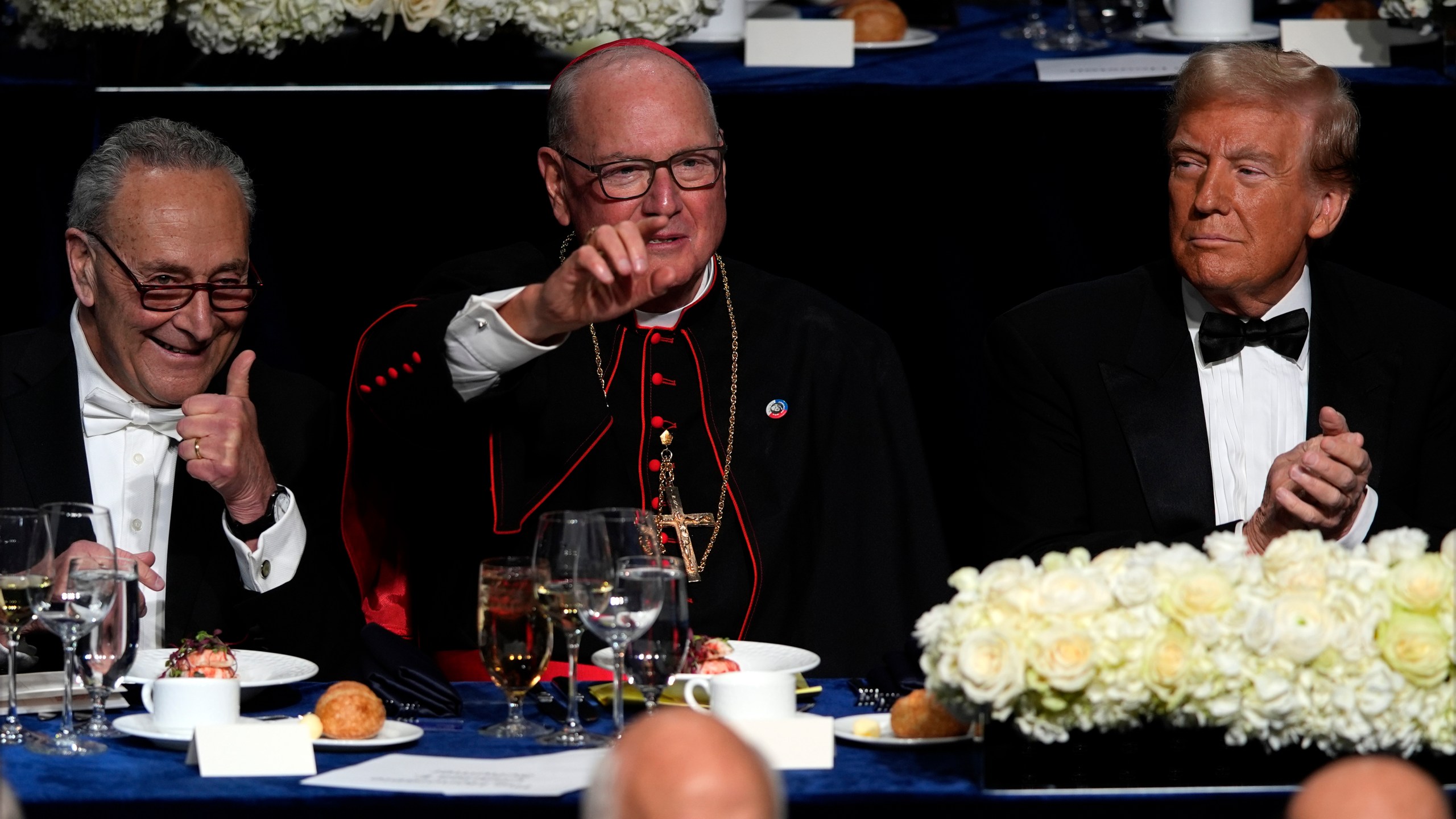 Senate Majority Leader Chuck Schumer of N.Y., and Cardinal Timothy Dolan gesture as Republican presidential nominee former President Donald Trump watches at the 79th annual Alfred E. Smith Memorial Foundation Dinner, Thursday, Oct. 17, 2024, in New York. (AP Photo/Julia Demaree Nikhinson)