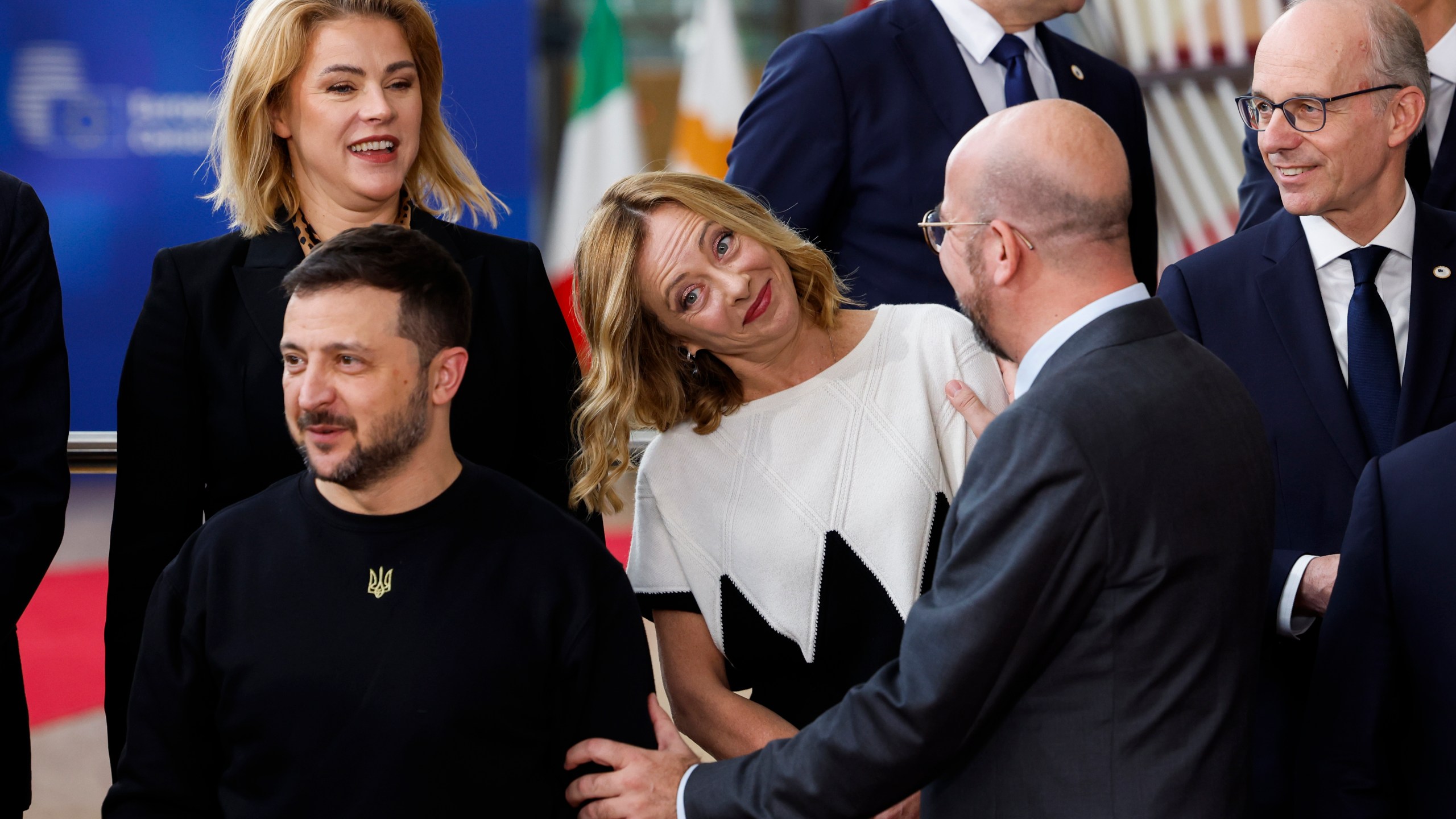 European Council President Charles Michel, second right, talks to Italy's Prime Minister Giorgia Meloni, center, next to Ukraine's President Volodymyr Zelenskyy, bottom left, as they arrive for a group photo during an EU summit in Brussels, Thursday, Oct. 17, 2024. (AP Photo/Geert Vanden Wijngaert)