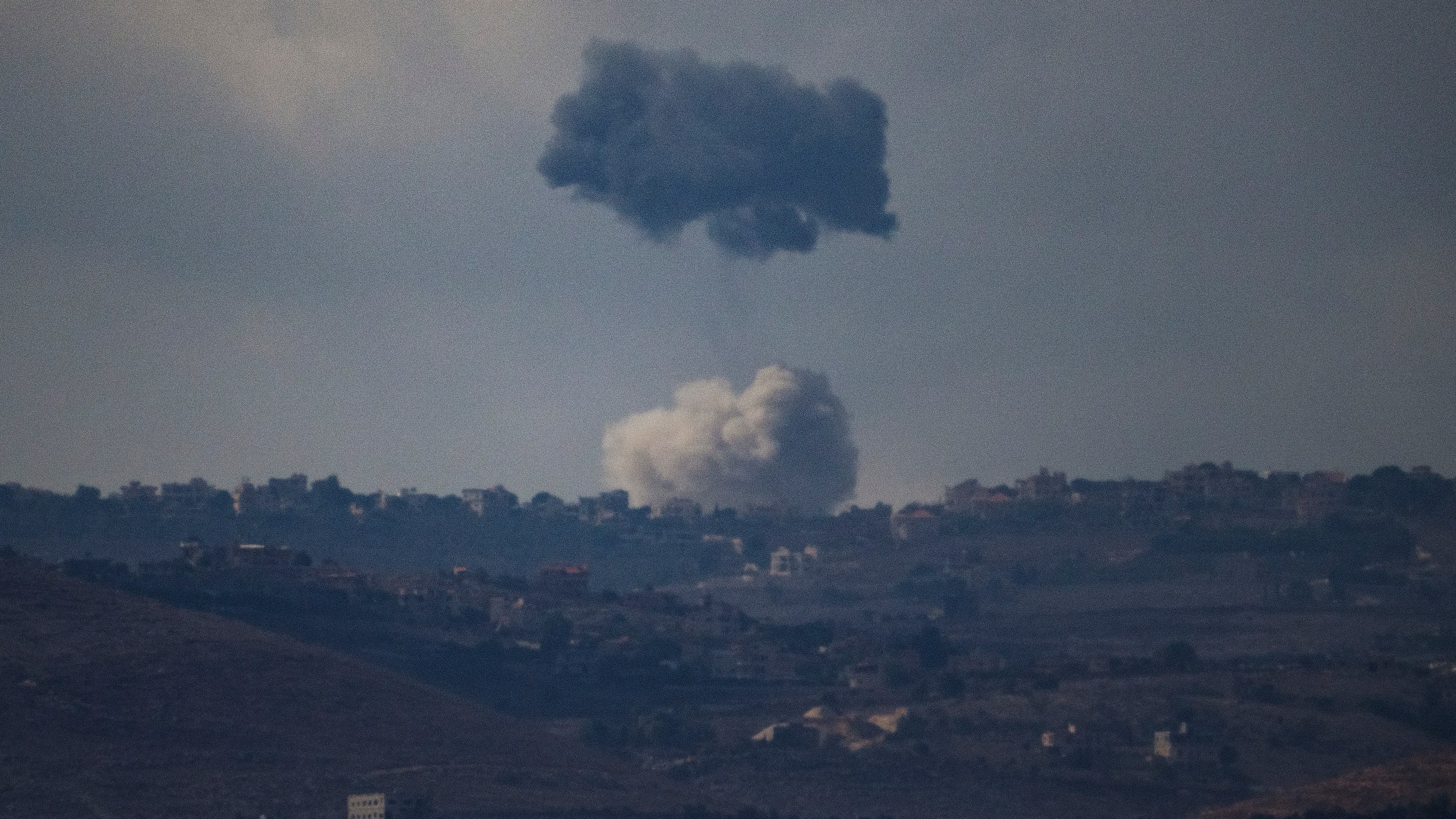 Smokes rise following an explosion in southern Lebanon as seen from northern Israel, Thursday, Oct. 17, 2024. (AP Photo/Leo Correa)