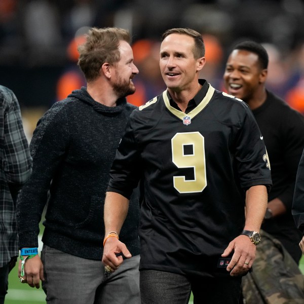 Former New Orleans Saints quarterback Drew Brews walks on the field before an NFL football game between the Saints and the Denver Broncos, Thursday, Oct. 17, 2024, in New Orleans. (AP Photo/Gerald Herbert)