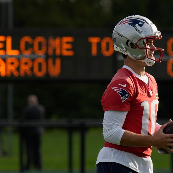 New England Patriots quarterback Drake Maye (10) works out during NFL football practice, Friday, Oct. 18, 2024, in Harrow, England. (AP Photo/Steve Luciano)