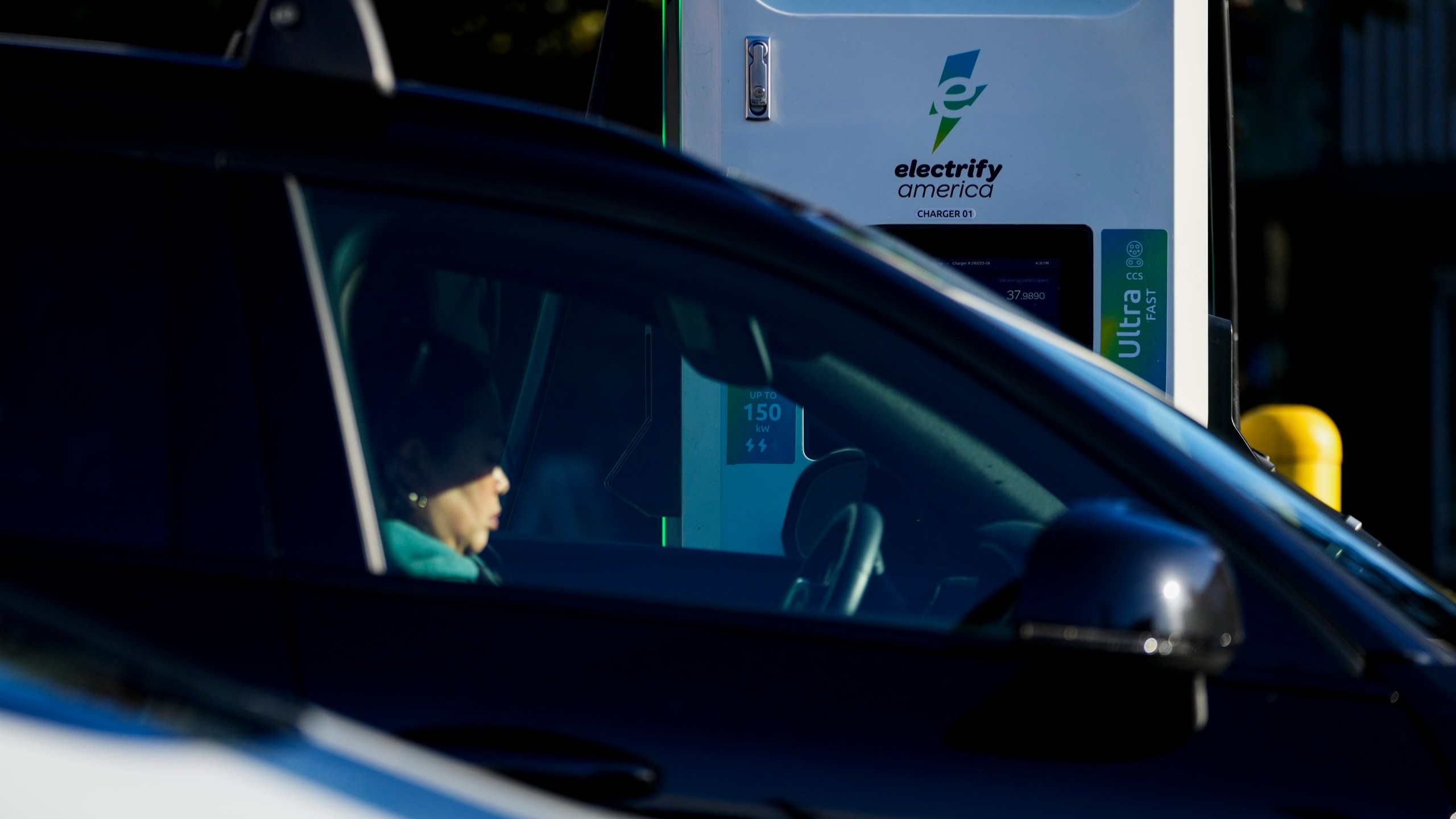 FILE - A driver waits in their car while charging their electric vehicles at an Electrify America station, Oct. 9, 2024, in Seattle. (AP Photo/Lindsey Wasson, File)