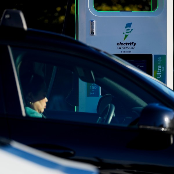 FILE - A driver waits in their car while charging their electric vehicles at an Electrify America station, Oct. 9, 2024, in Seattle. (AP Photo/Lindsey Wasson, File)