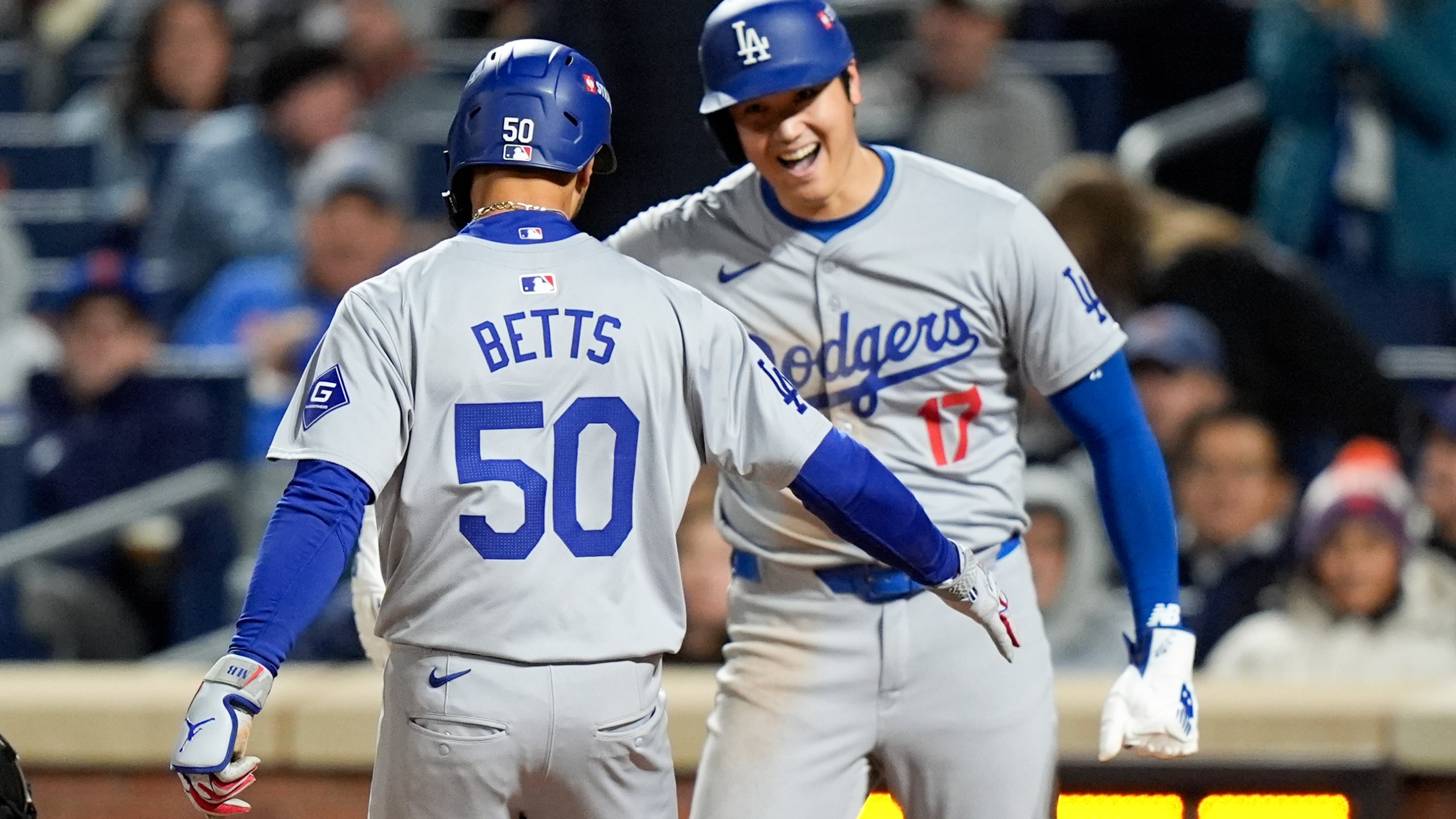 Los Angeles Dodgers' Shohei Ohtani celebrates after scoring on Mookie Betts two-run home run against the New York Mets during the sixth inning in Game 4 of a baseball NL Championship Series, Thursday, Oct. 17, 2024, in New York. (AP Photo/Frank Franklin II)