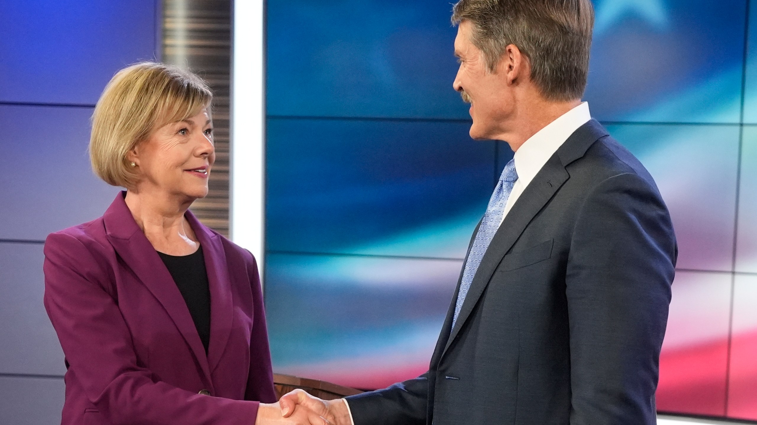 Wisconsin Senate candidates Republican Eric Hovde and Democratic U.S. Sen. Tammy Baldwin shake hands before a televised debate Friday, Oct. 18, 2024, in Madison, Wis. (AP Photo/Morry Gash)