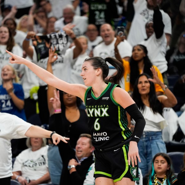 Minnesota Lynx forward Bridget Carleton (6) reacts to a 3-point basket against the New York Liberty during the second half of Game 4 of a WNBA basketball final playoff series, Friday, Oct. 18, 2024, in Minneapolis. (AP Photo/Abbie Parr)