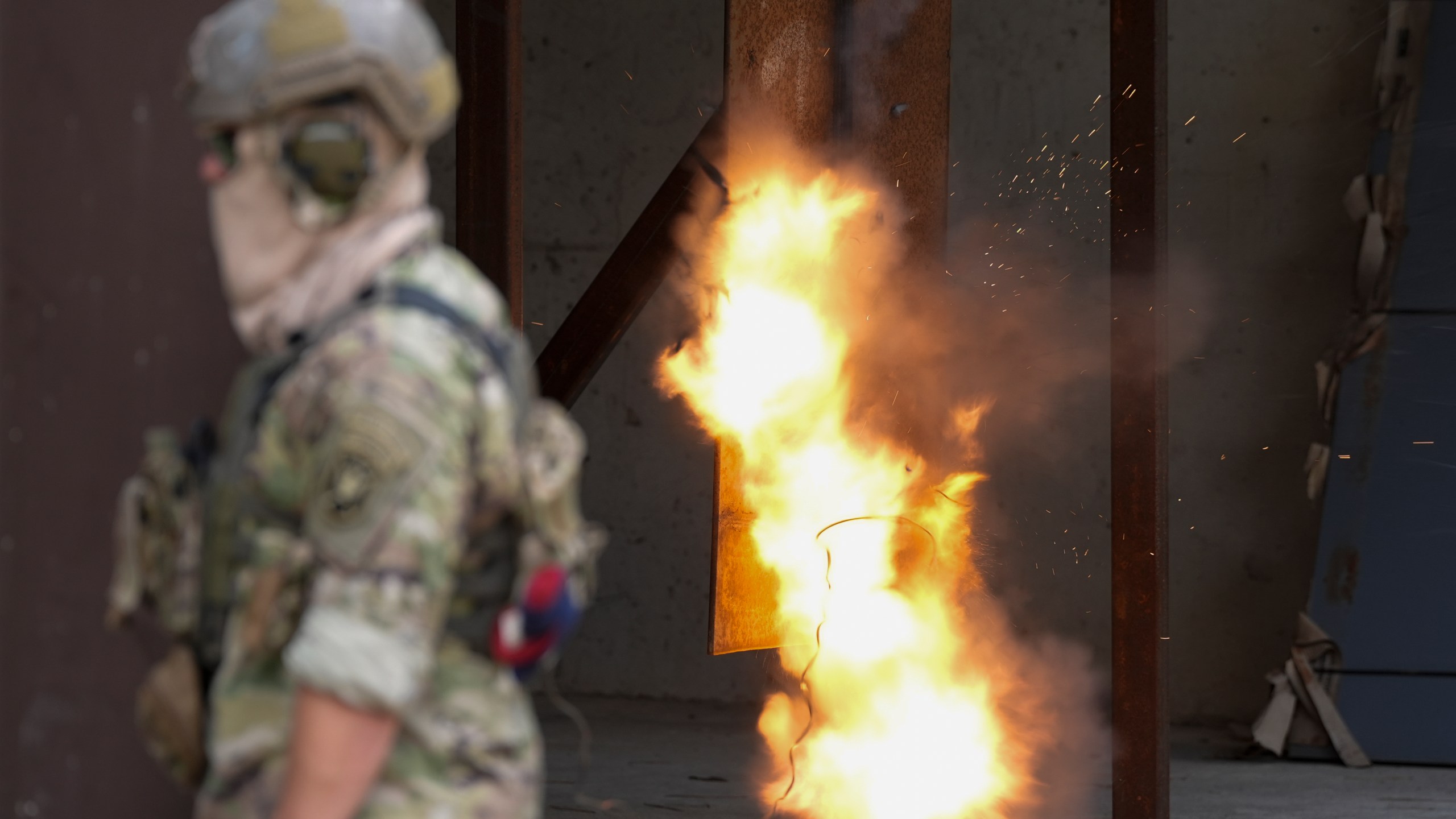 A U.S. special forces soldier sets off a reshaped explosive charge that's noticeably smaller to reduce its blowback on troops, Thursday, Sept. 19, 2024, at at Fort Liberty in Fayetteville, N.C. Special Operations Command is developing ways to better protect warfighters and evaluate their health risks, particularly during training. (AP Photo/Chris Carlson)