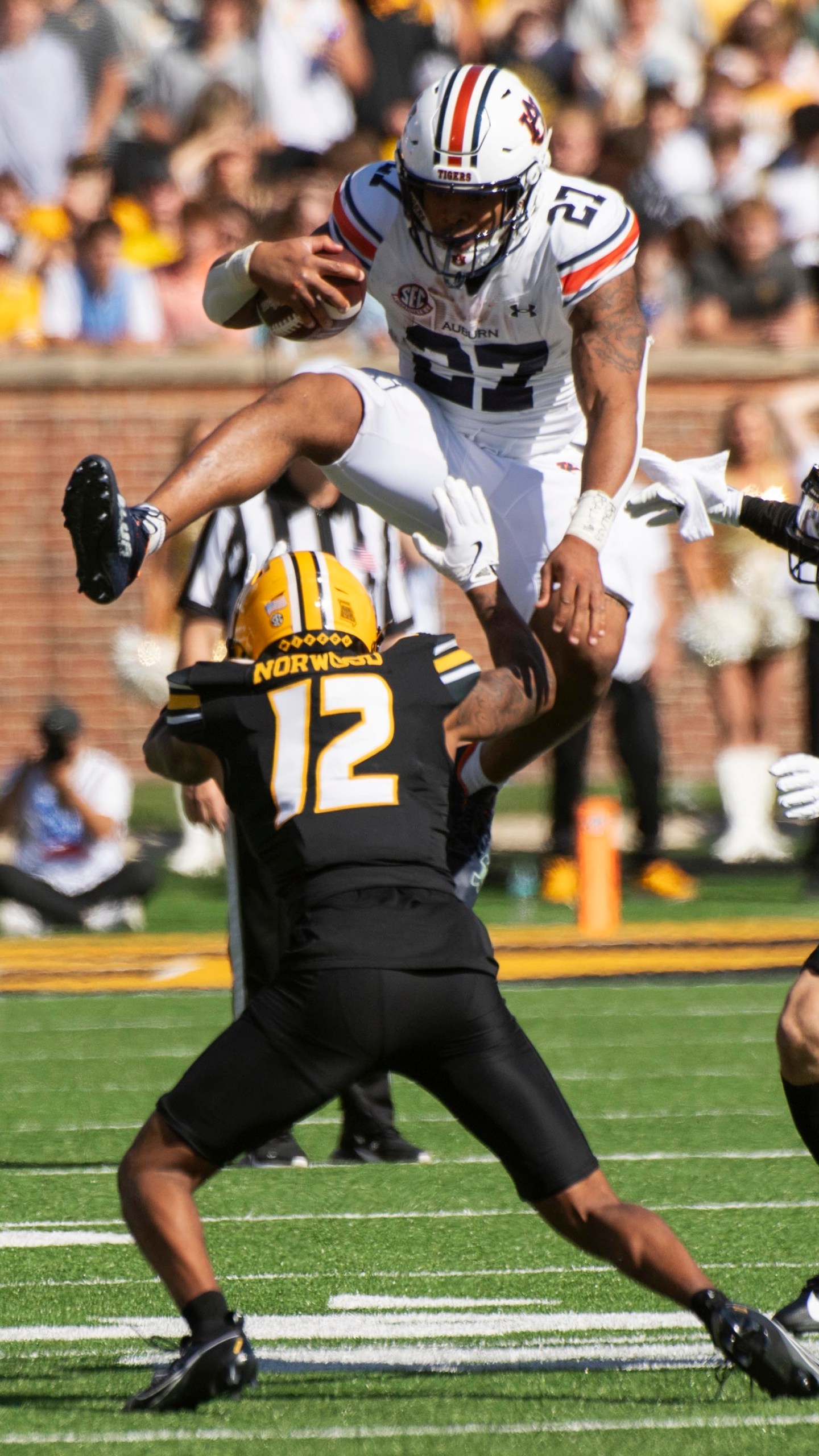 Auburn running back Jarquez Hunter, top, leaps over Missouri cornerback Dreyden Norwood during the first half of an NCAA college football game Saturday, Oct. 19, 2024, in Columbia, Mo. (AP Photo/L.G. Patterson)