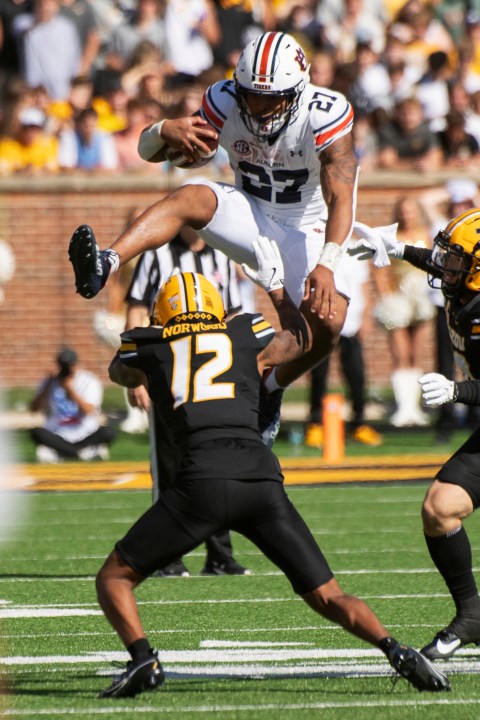 Auburn running back Jarquez Hunter, top, leaps over Missouri cornerback Dreyden Norwood during the first half of an NCAA college football game Saturday, Oct. 19, 2024, in Columbia, Mo. (AP Photo/L.G. Patterson)