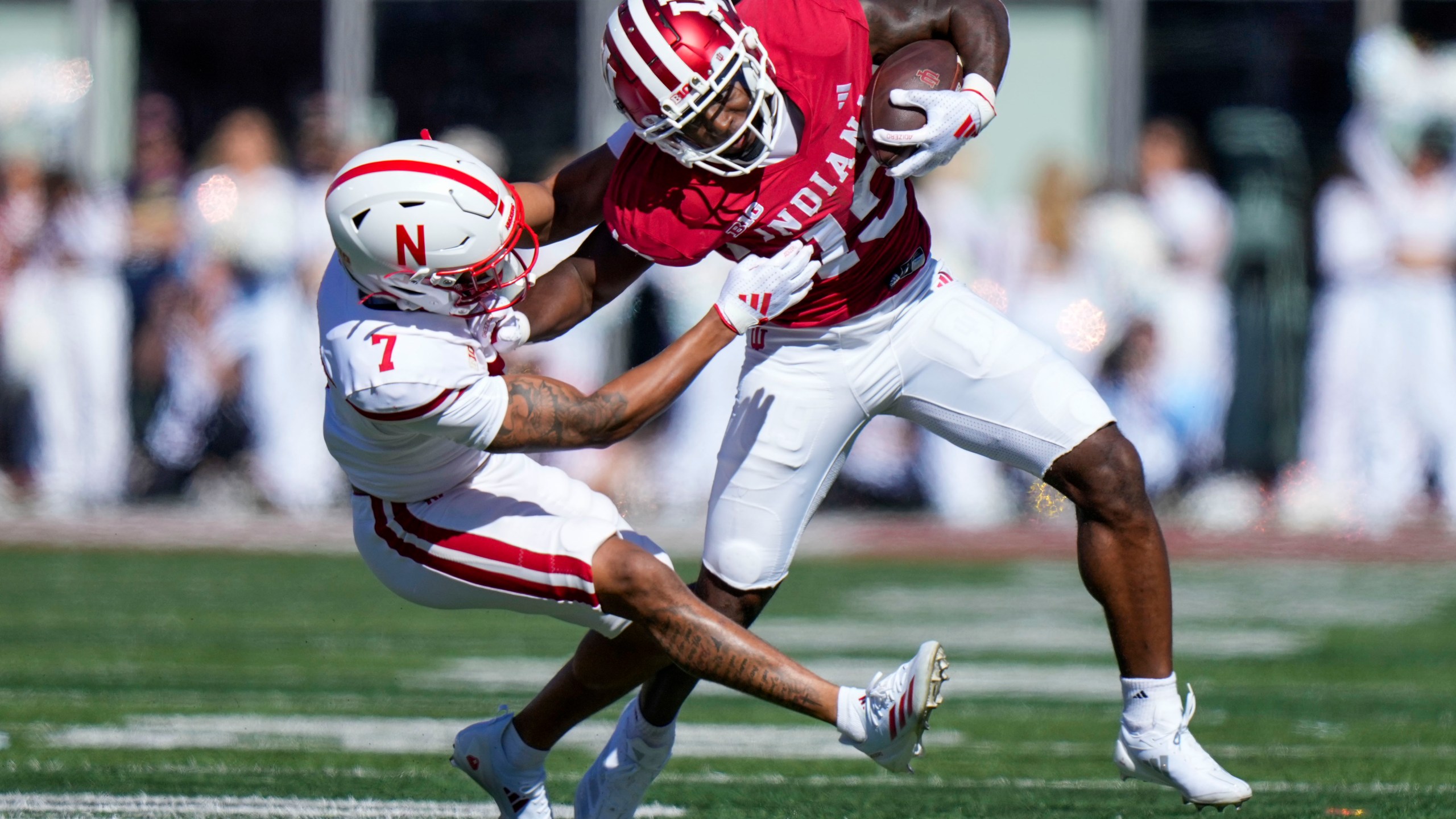 Indiana wide receiver Miles Cross, right, gets tackled by Nebraska defensive back Malcolm Hartzog Jr. (7) during the first half of an NCAA college football game in Bloomington, Ind., Saturday, Oct. 19, 2024. (AP Photo/AJ Mast)