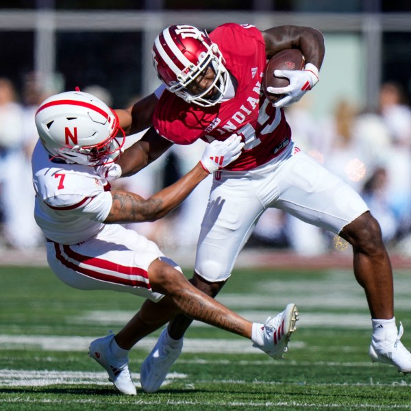 Indiana wide receiver Miles Cross, right, gets tackled by Nebraska defensive back Malcolm Hartzog Jr. (7) during the first half of an NCAA college football game in Bloomington, Ind., Saturday, Oct. 19, 2024. (AP Photo/AJ Mast)