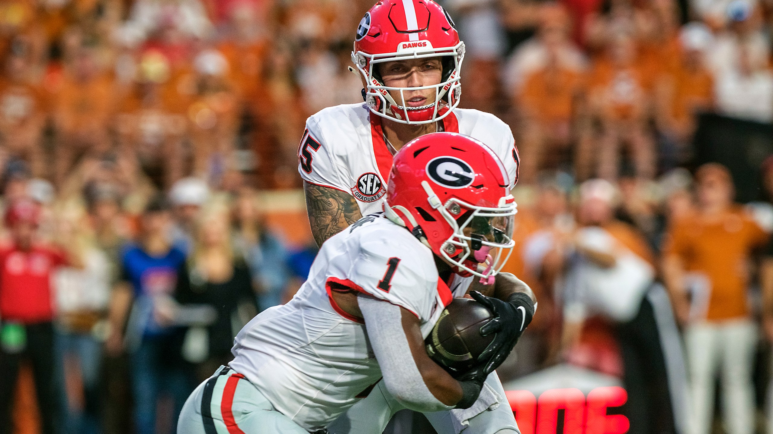 Georgia quarterback Carson Beck (15) hands the ball off to Georgia running back Trevor Etienne (1) during the first half of an NCAA college football game against Texas in Austin, Texas, Saturday, Oct. 19, 2024. (AP Photo/Rodolfo Gonzalez)