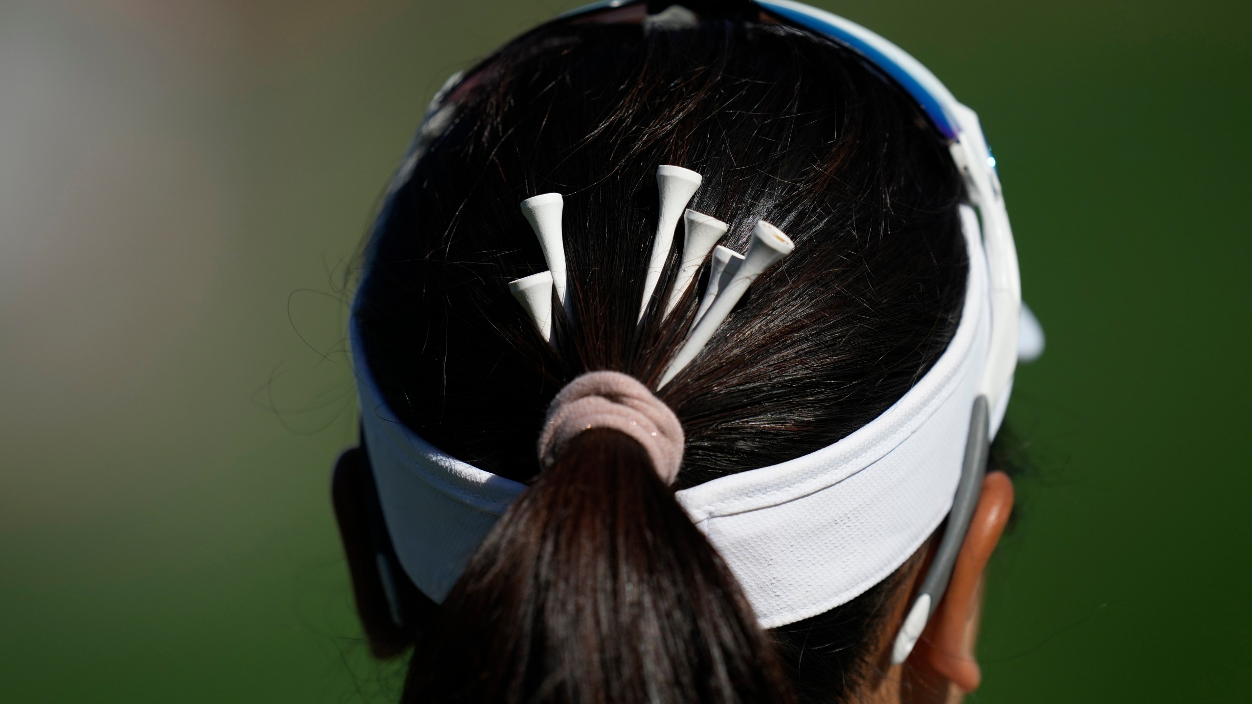 Chanettee Wannasaen of Thailand has tees in her hair on the 3rd green during the final round of the LPGA Ladies Championship golf tournament at the Seowon Valley Country Club in Paju, South Korea, Sunday, Oct. 20, 2024. (AP Photo/Lee Jin-man)