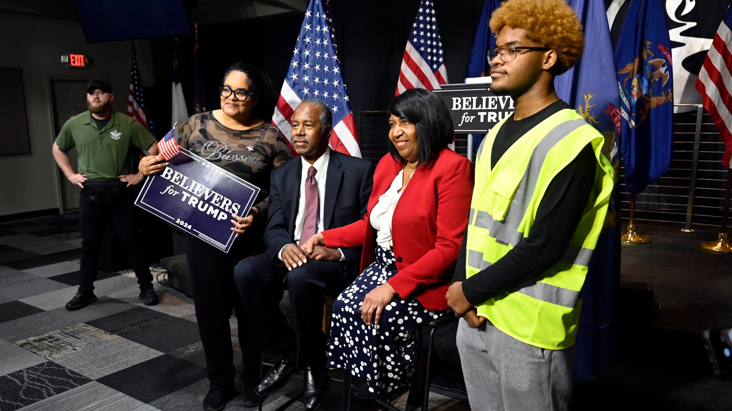 Ben Carson, center, and his wife Candy Carson, right center, pose for a photo with Tiffany King, second from left, and her son, Nehemiah King, right, following Carson's address to supporters of Republican presidential nominee former President Donald Trump, Saturday, Oct. 5, 2024, in Livonia, Mich. (AP Photo/Jose Juarez)