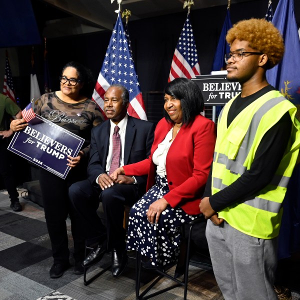 Ben Carson, center, and his wife Candy Carson, right center, pose for a photo with Tiffany King, second from left, and her son, Nehemiah King, right, following Carson's address to supporters of Republican presidential nominee former President Donald Trump, Saturday, Oct. 5, 2024, in Livonia, Mich. (AP Photo/Jose Juarez)