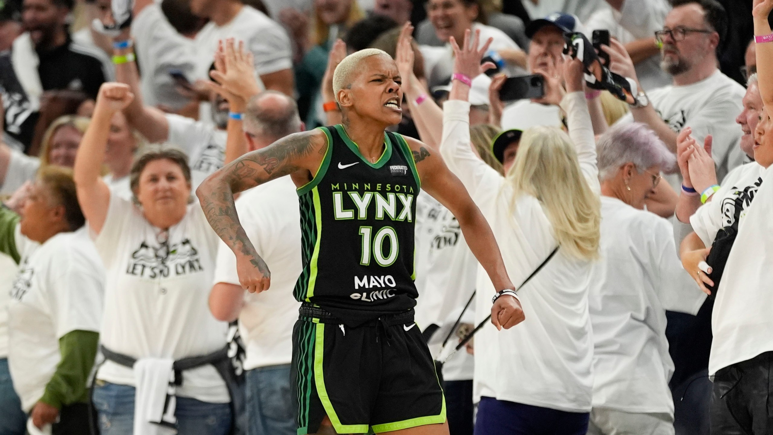 Minnesota Lynx guard Courtney Williams (10) reacts after defeating the New York Liberty after Game 4 of a WNBA basketball final playoff series, Friday, Oct. 18, 2024, in Minneapolis. The Lynx won 82-80, forcing a Game 5 in the series. (AP Photo/Abbie Parr)