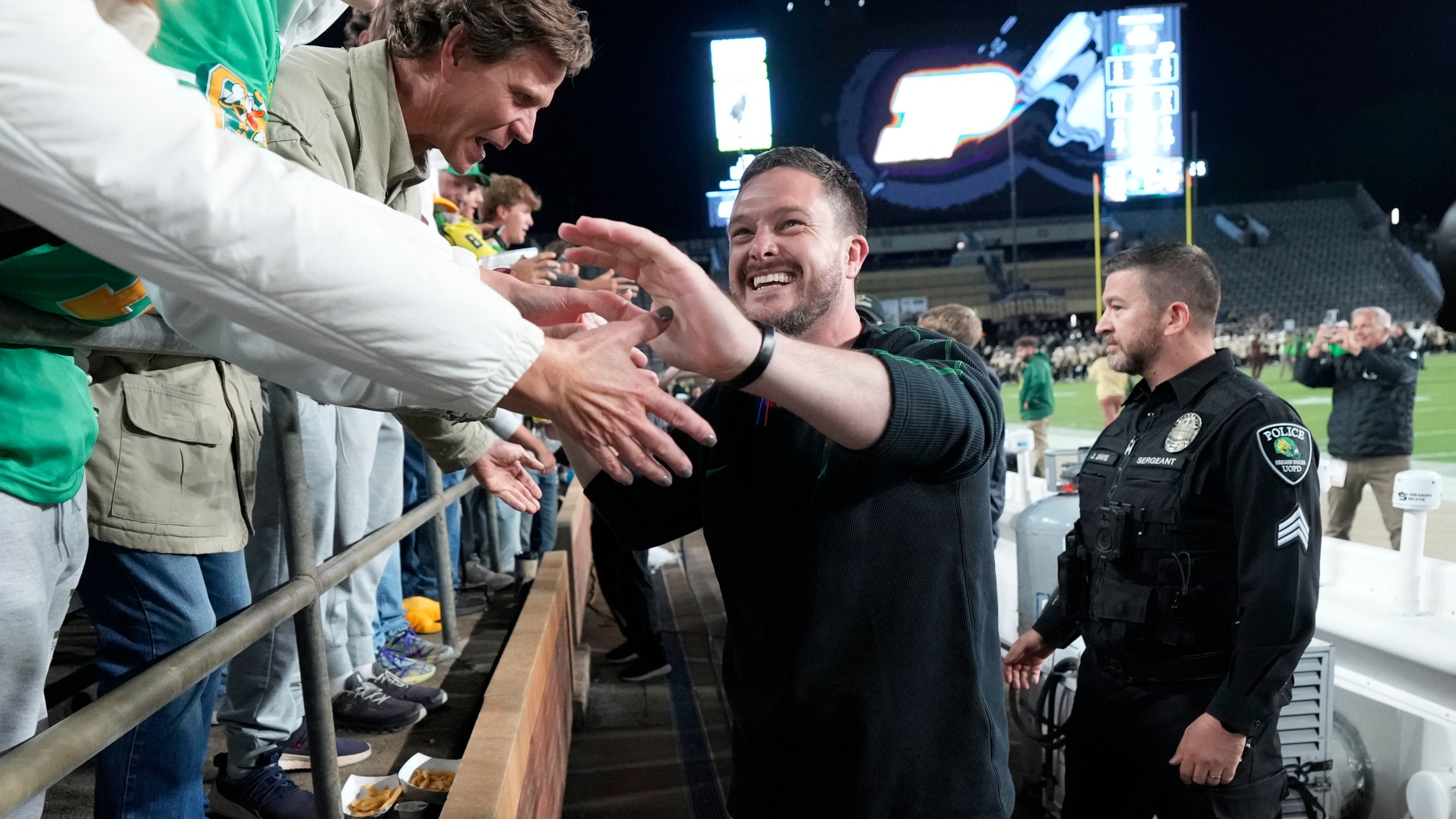 Oregon head coach Dan Lanning celebrates with fans after his team defeated Purdue in an NCAA college football game in West Lafayette, Ind., Friday, Oct. 18, 2024. (AP Photo/AJ Mast)