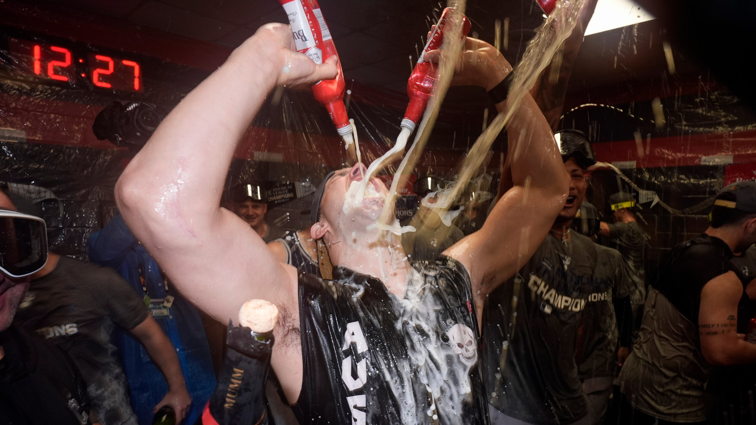 New York Yankees' Tommy Kahnle celebrates in the clubhouse after Game 5 of the baseball AL Championship Series against the Cleveland Guardians Sunday, Oct. 20, 2024, in Cleveland. The Yankees won 5-2 to advance to the World Series. (AP Photo/Godofredo A. Vásquez )