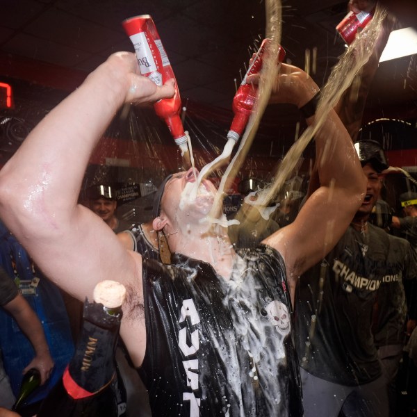 New York Yankees' Tommy Kahnle celebrates in the clubhouse after Game 5 of the baseball AL Championship Series against the Cleveland Guardians Sunday, Oct. 20, 2024, in Cleveland. The Yankees won 5-2 to advance to the World Series. (AP Photo/Godofredo A. Vásquez )