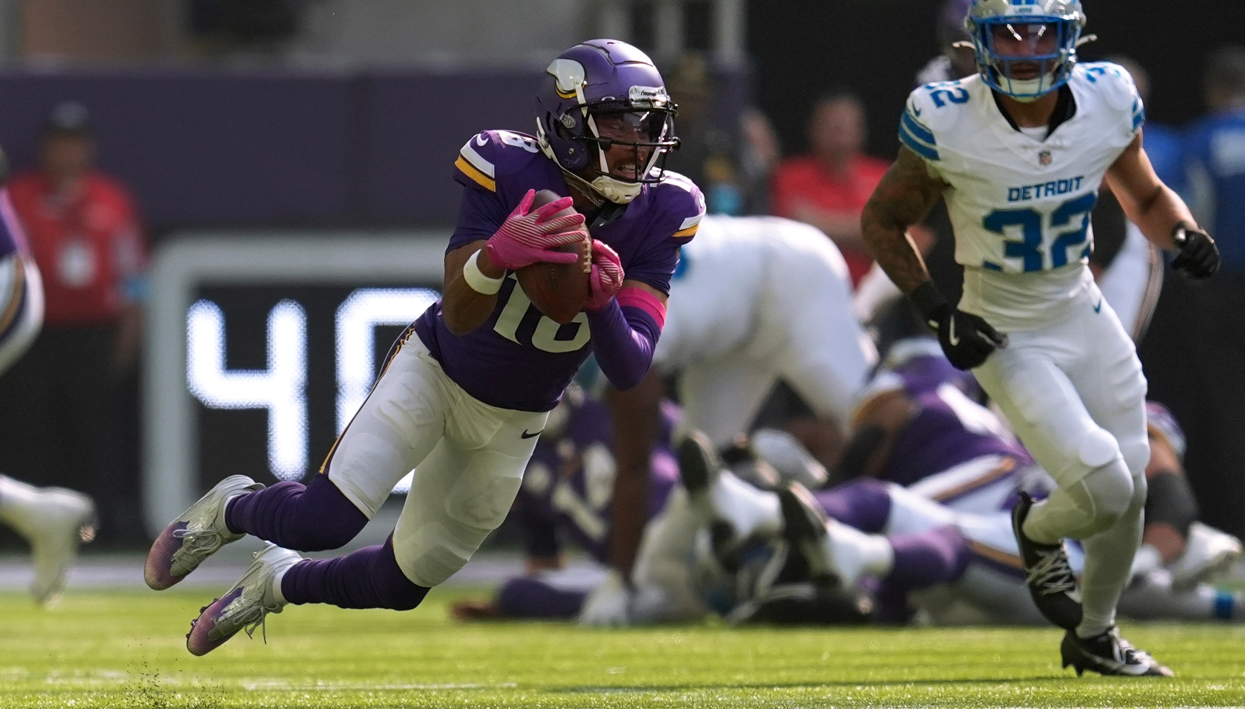 Minnesota Vikings wide receiver Justin Jefferson (18) catches a pass as Detroit Lions safety Brian Branch (32) defends during the first half of an NFL football game Sunday, Oct. 20, 2024, in Minneapolis. (AP Photo/Abbie Parr)