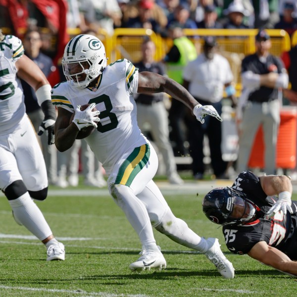 Green Bay Packers running back Josh Jacobs (8) runs for a touchdown during the second half of an NFL football game against the Houston Texans, Sunday, Oct. 20, 2024, in Green Bay, Wis. (AP Photo/Mike Roemer)