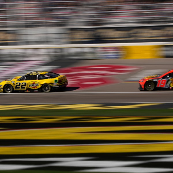 NASCAR Cup Series drivers Joey Logano (22) and Martin Truex Jr. (19) race during a NASCAR Cup Series auto race Sunday, Oct. 20, 2024, in Las Vegas. (AP Photo/John Locher)