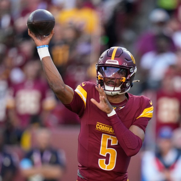 Washington Commanders quarterback Jayden Daniels throws a pass during the first half of an NFL football game against the Carolina Panthers, Sunday, Oct. 20, 2024, in Landover, Md. (AP Photo/Stephanie Scarbrough)