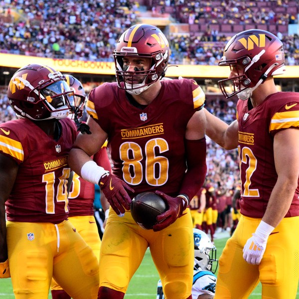 Washington Commanders tight end Zach Ertz (86) celebrates with teammates after catching a 12-yard touchdown pass during the first half of an NFL football game against the Carolina Panthers, Sunday, Oct. 20, 2024, in Landover, Md. (AP Photo/Nick Wass)