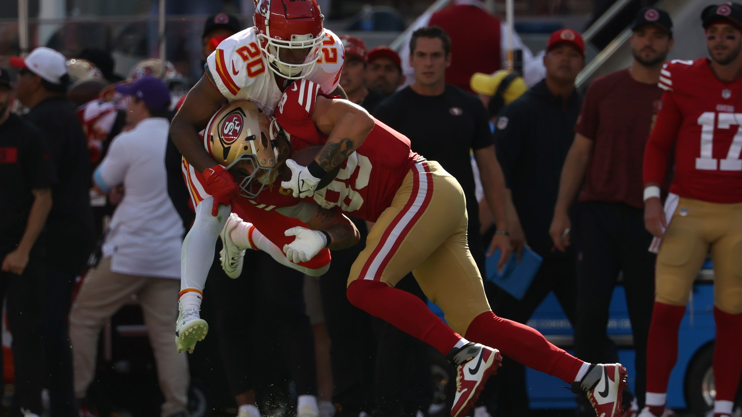 San Francisco 49ers tight end George Kittle, bottom, catches a pass against Kansas City Chiefs safety Justin Reid during the first half of an NFL football game in Santa Clara, Calif., Sunday, Oct. 20, 2024. (AP Photo/Jed Jacobsohn)