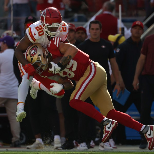 San Francisco 49ers tight end George Kittle, bottom, catches a pass against Kansas City Chiefs safety Justin Reid during the first half of an NFL football game in Santa Clara, Calif., Sunday, Oct. 20, 2024. (AP Photo/Jed Jacobsohn)