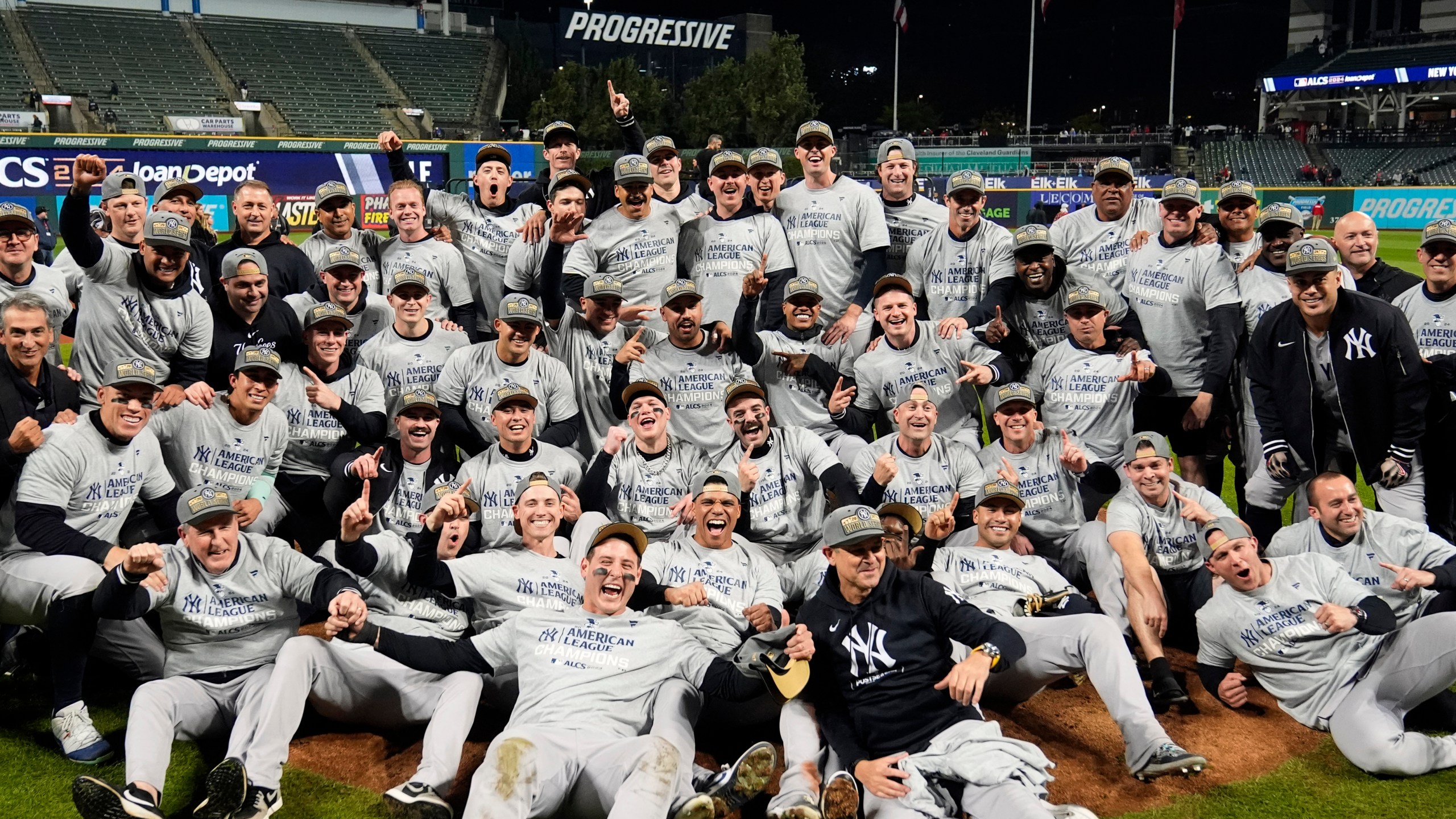 New York Yankees players pose for a team picture after Game 5 of the baseball AL Championship Series against the Cleveland Guardians Saturday, Oct. 19, 2024, in Cleveland. The Yankees won 5-2 to advance to the World Series. (AP Photo/Sue Ogrocki)