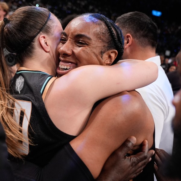 New York Liberty forward Kayla Thornton (5) hugs guard Sabrina Ionescu (20) after the Liberty defeated the Minnesota Lynx in Game 5 of the WNBA basketball final series to win the championship, Sunday, Oct. 20, 2024, in New York. (AP Photo/Pamela Smith)