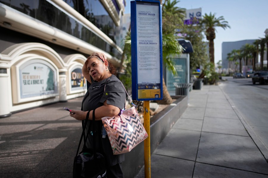 Haydee Zetino waits for the bus after working a shift as a maid at Harrah's hotel-casino along the Las Vegas Strip, Thursday, Sept. 12, 2024, in Las Vegas. Zetino, an immigrant from El Salvador, gained temporary protected status since arriving in the wake of a major earthquake in 2001. (AP Photo/John Locher)