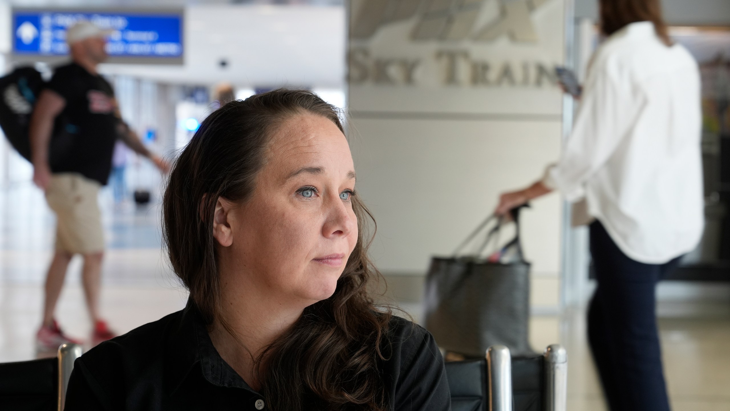 Lindsay Ruck, a server at Phoenix Sky Harbor International Airport restaurants, pauses in Terminal 3 as she works for minimum wage plus tips and is interested in the upcoming election and the Arizona Prop 138 on minimum wage vote Thursday, Oct. 3, 2024, in Phoenix. (AP Photo/Ross D. Franklin)