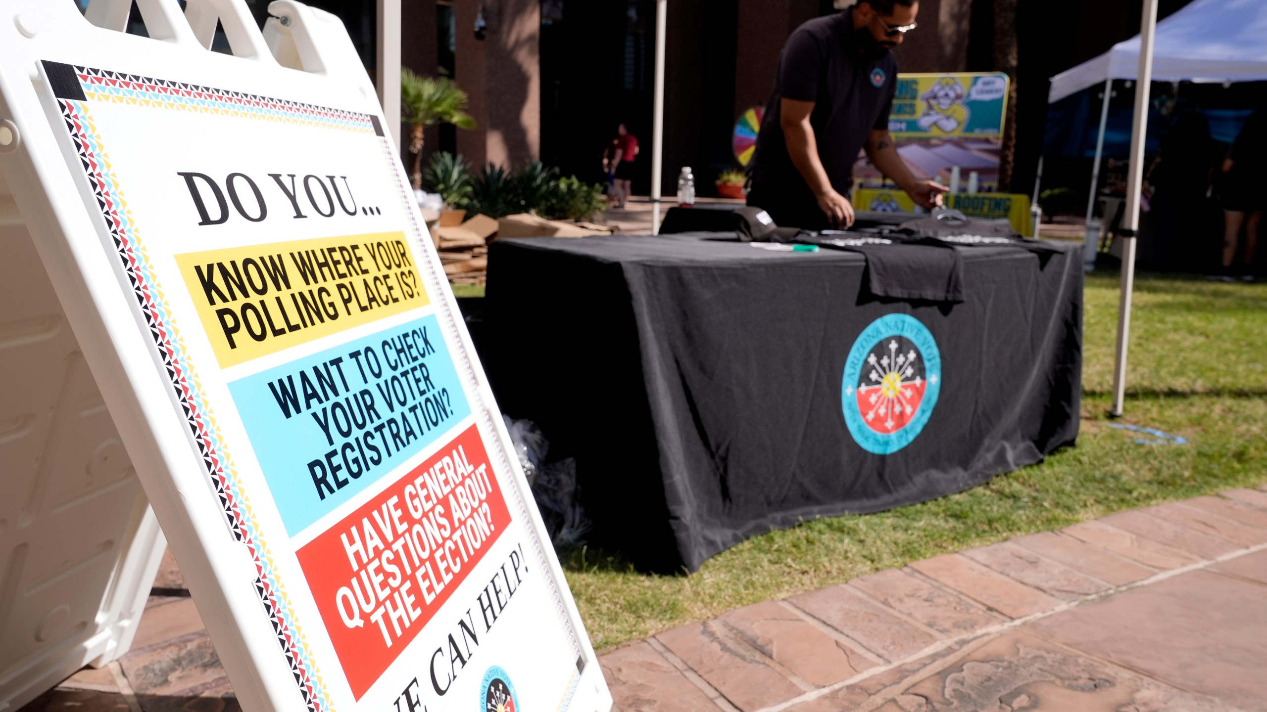 The Inter Tribal Council of Arizona, Inc., has a Arizona Native Vote booth at an Indigenous Peoples' Day event, Monday, Oct. 14, 2024, in Phoenix. (AP Photo/Ross D. Franklin)