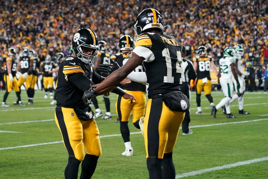 Pittsburgh Steelers wide receiver George Pickens (14) celebrates his touchdown reception against New York Jets with Pittsburgh Steelers quarterback Russell Wilson (3) the first half of an NFL football game in Pittsburgh, Sunday, Oct. 20, 2024. (AP Photo/Matt Freed)