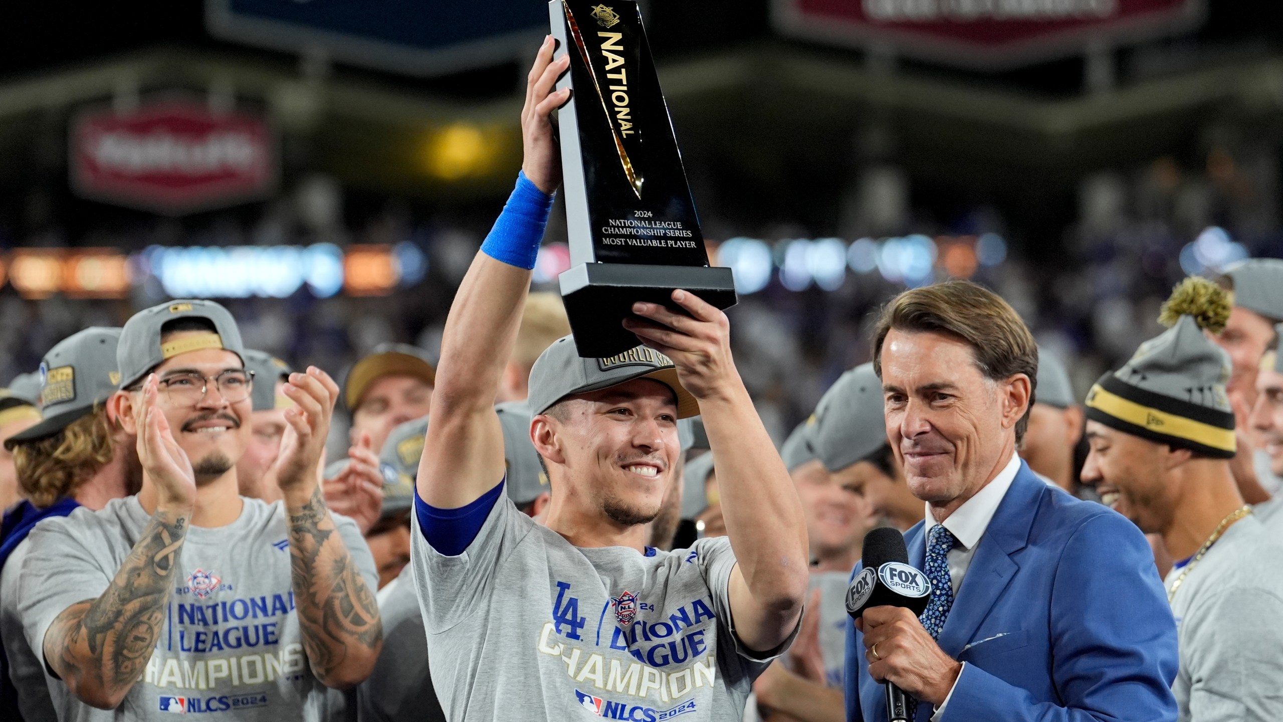 Los Angeles Dodgers' Tommy Edman celebrates after their win against the New York Mets in Game 6 of a baseball NL Championship Series, Sunday, Oct. 20, 2024, in Los Angeles. The Dodgers will face the New York Yankees in the World. (AP Photo/Ashley Landis)