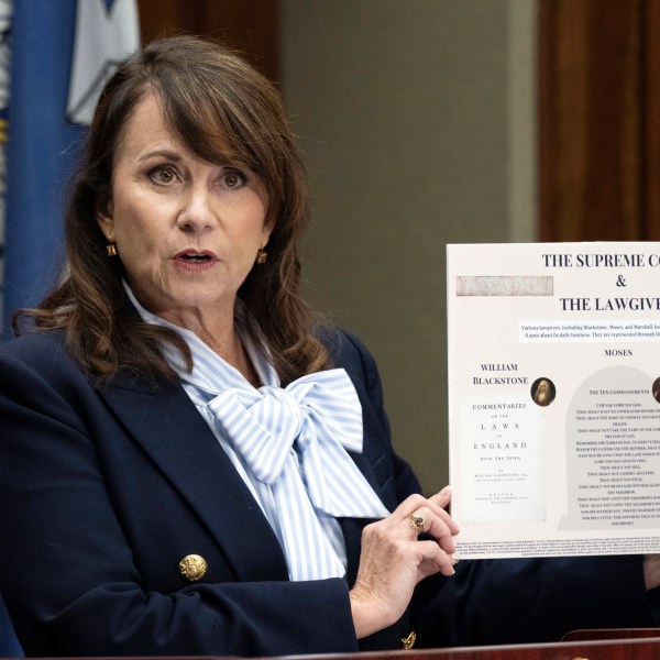 FILE - Louisiana Attorney General Liz Murrill speaks holds up a mini-display showing the Ten Commandments during a press conference regarding the Ten Commandments in schools, Aug. 5, 2024, in Baton Rouge, La. (Hilary Scheinuk/The Advocate via AP, File)