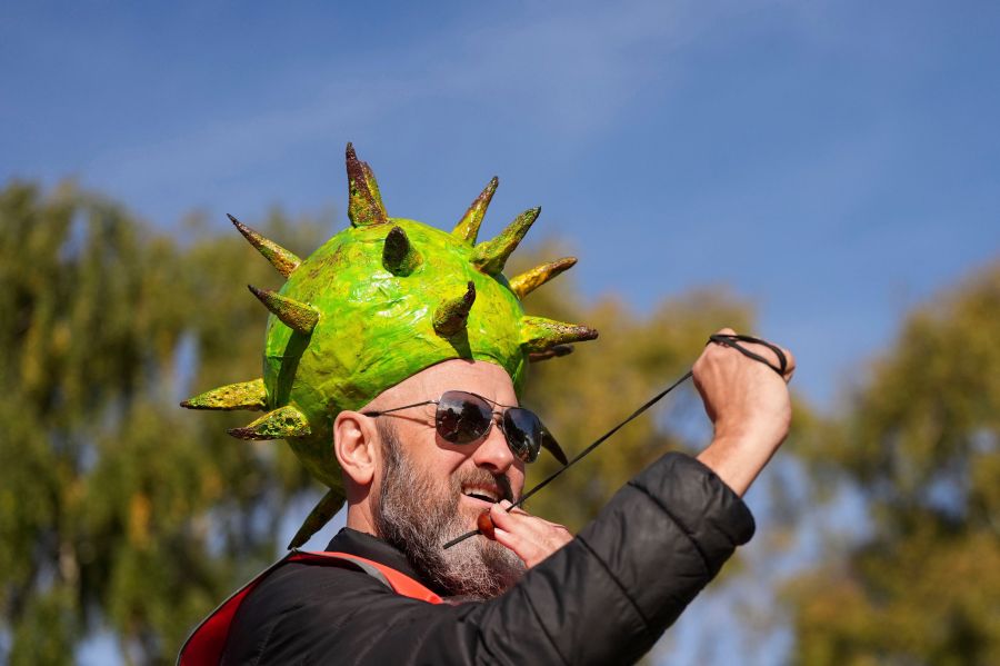 Competitor Neil Morbey wearing a conker themed hat takes part in the annual World Conker Championships at the Shuckburgh Arms in Southwick, Peterborough, England, Sunday Oct. 13, 2024. (Jacob King/PA via AP)