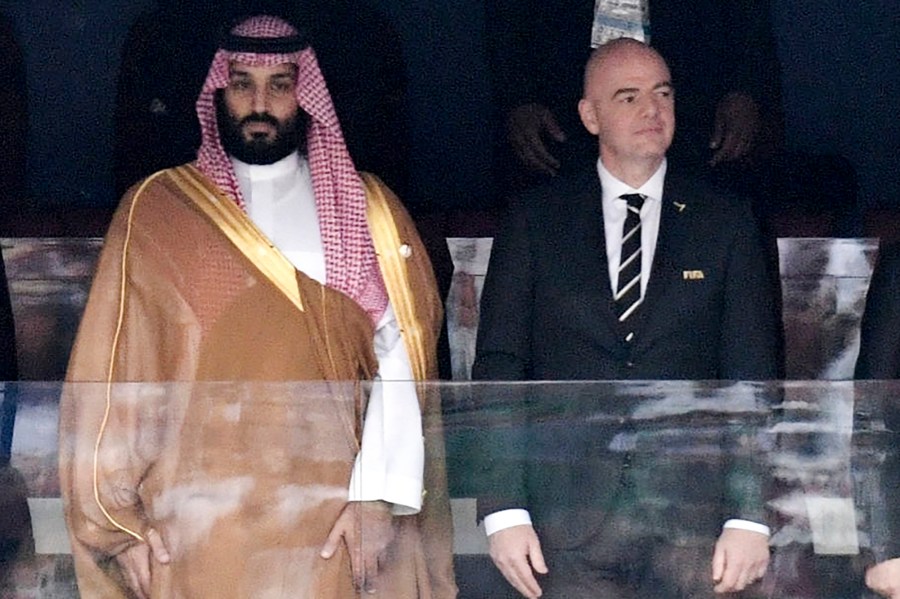 FILE - Saudi Arabia Crown Prince Mohammed bin Salman, left, and FIFA President Gianni Infantino, stand for the anthem prior to the match between Russia and Saudi Arabia which opened the 2018 soccer World Cup at the Luzhniki stadium in Moscow, Russia, on June 14, 2018. (Alexei Nikolsky, Sputnik, Kremlin Pool Photo via AP, File)