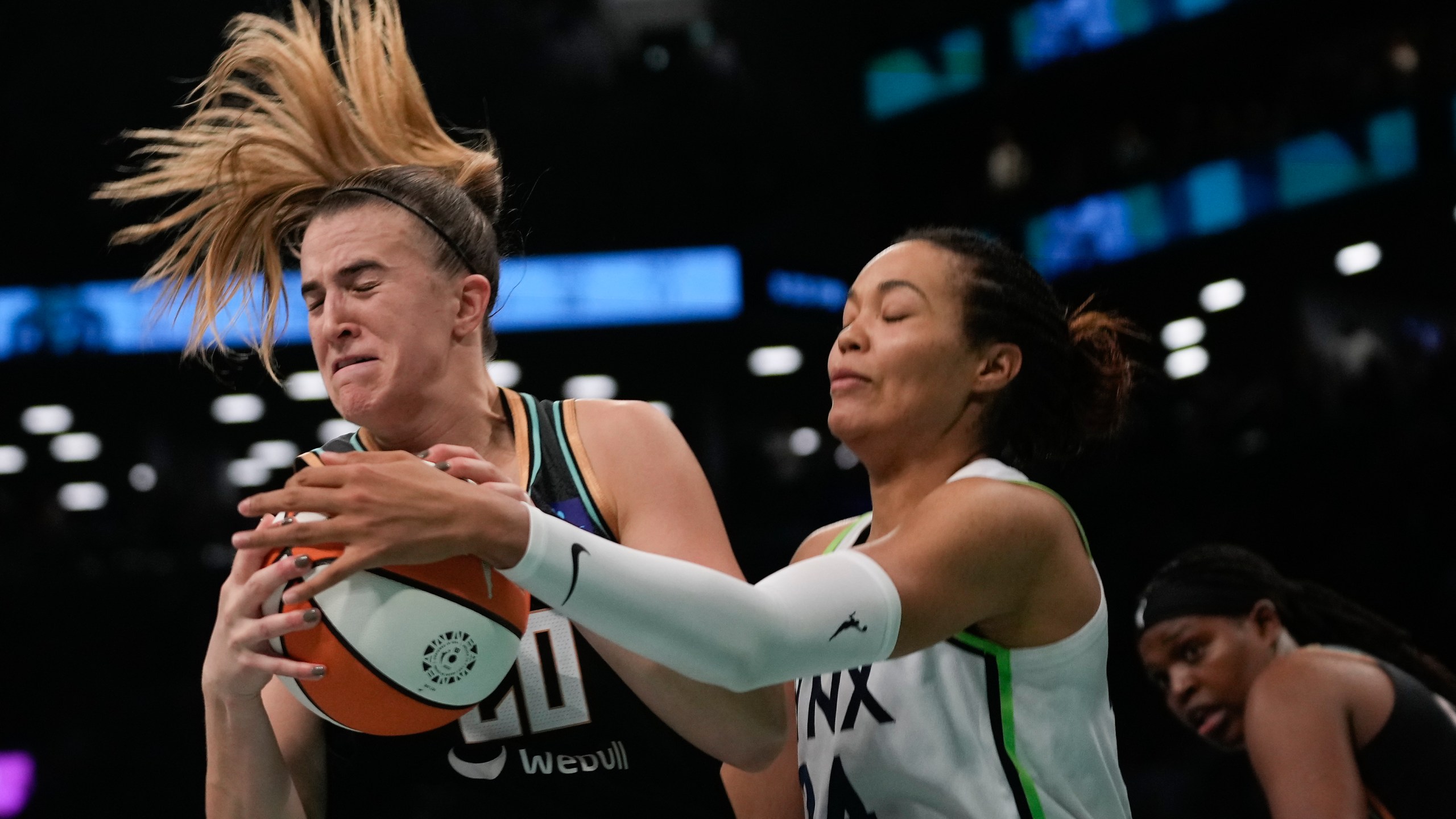 New York Liberty guard Sabrina Ionescu (20) battles for a rebound against Minnesota Lynx forward Napheesa Collier (24) during the fourth quarter of Game 5 of the WNBA basketball final series, Sunday, Oct. 20, 2024, in New York. (AP Photo/Pamela Smith)