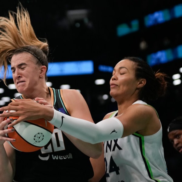 New York Liberty guard Sabrina Ionescu (20) battles for a rebound against Minnesota Lynx forward Napheesa Collier (24) during the fourth quarter of Game 5 of the WNBA basketball final series, Sunday, Oct. 20, 2024, in New York. (AP Photo/Pamela Smith)