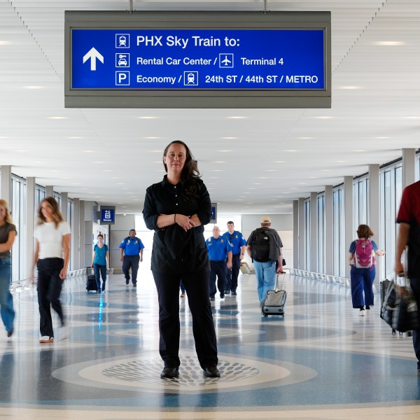 Lindsay Ruck, a server at Phoenix Sky Harbor International Airport restaurants, pauses in Terminal 3 as she is anticipates the vote on Arizona Prop 138 on minimum wage Thursday, Oct. 3, 2024, in Phoenix. (AP Photo/Ross D. Franklin)