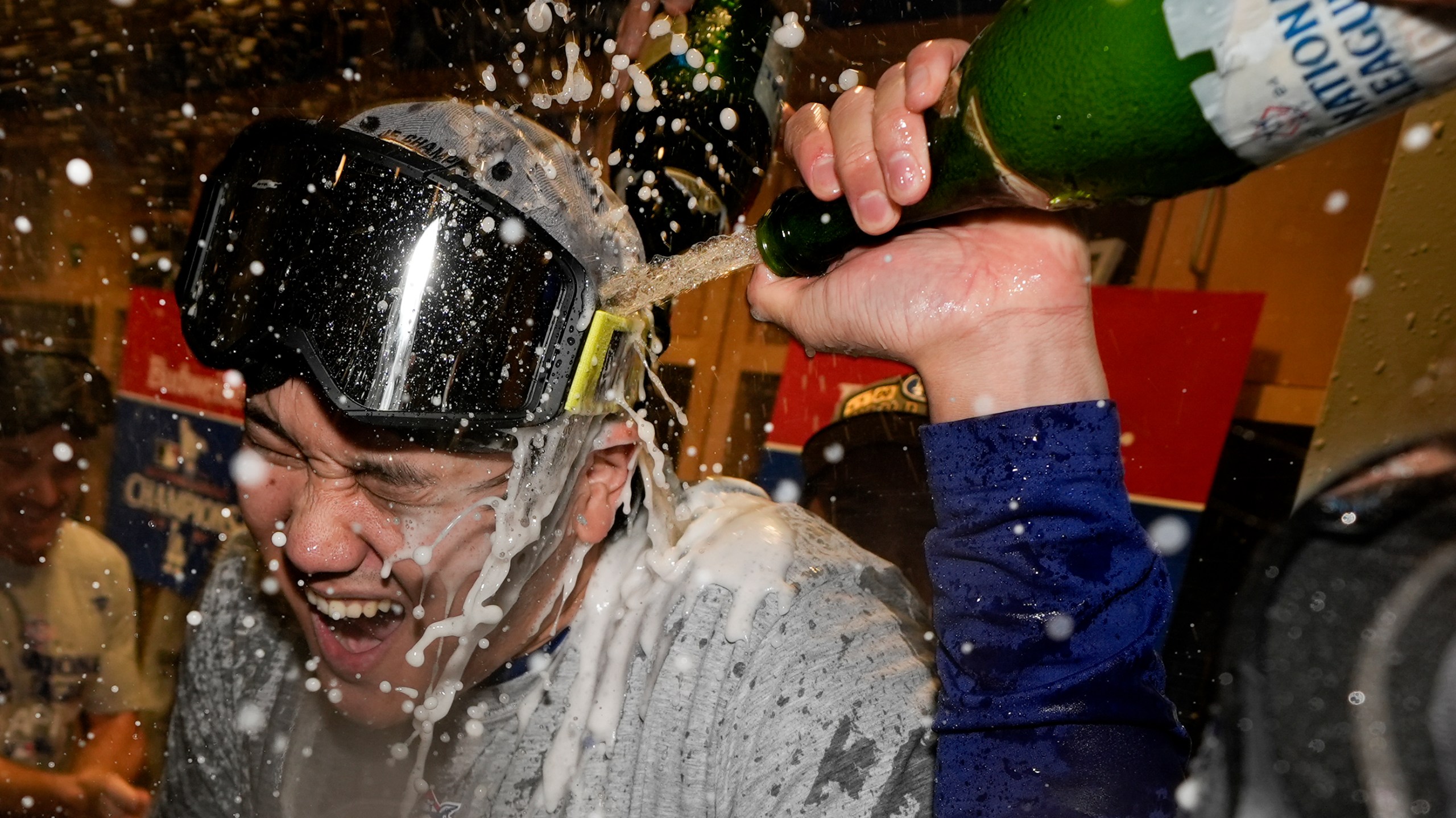 Los Angeles Dodgers Shohei Ohtani celebrates in the locker room after their win against the New York Mets in Game 6 of a baseball NL Championship Series, Sunday, Oct. 20, 2024, in Los Angeles. The Dodgers will face the New York Yankees in the World (AP Photo/Ashley Landis)