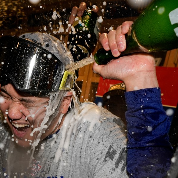 Los Angeles Dodgers Shohei Ohtani celebrates in the locker room after their win against the New York Mets in Game 6 of a baseball NL Championship Series, Sunday, Oct. 20, 2024, in Los Angeles. The Dodgers will face the New York Yankees in the World (AP Photo/Ashley Landis)