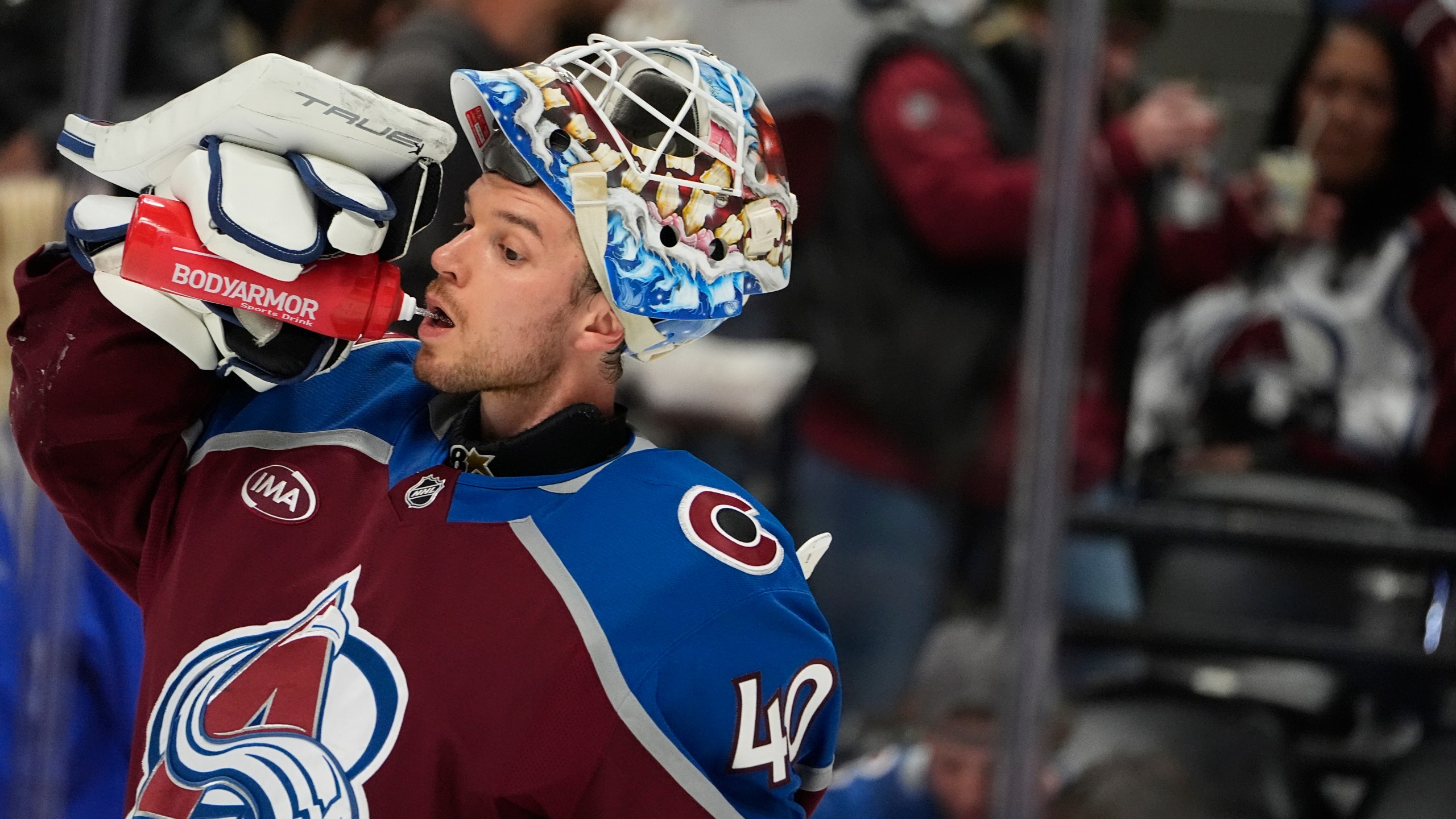 Colorado Avalanche goaltender Alexandar Georgiev drinks during a timeout in the second period of an NHL hockey game against the Anaheim Ducks, Friday, Oct. 18, 2024, in Denver. (AP Photo/David Zalubowski)